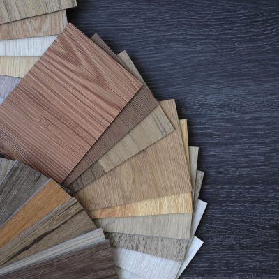Laminate Wood Concept - Samples of laminate and vinyl floor tile on wooden Background wo Laminate wood flooring samples